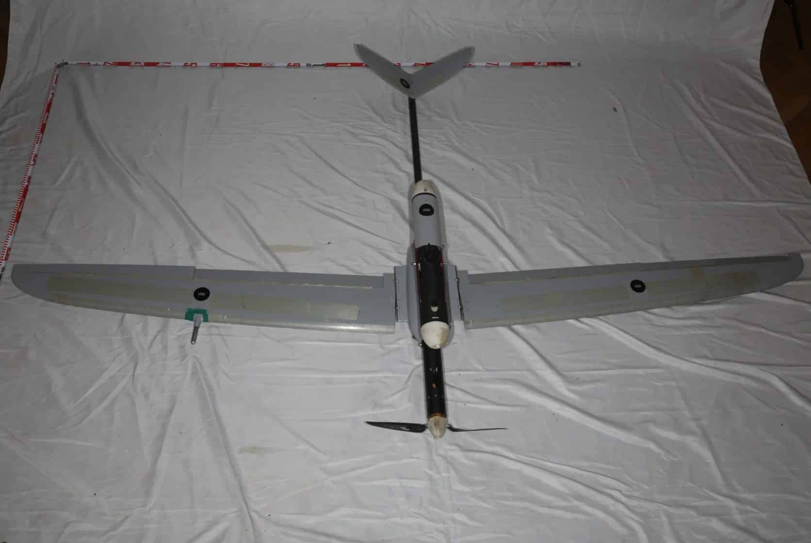 Captured Lastochka-M fixed-wing drone laid out on a white sheet.