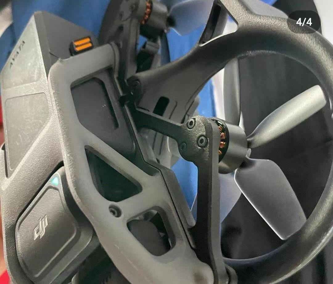 The flight battery seated in the Avata, orange release strips running down each side.