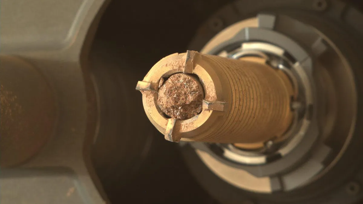 Close-up of a sealed sample tube holding reddish Martian soil.