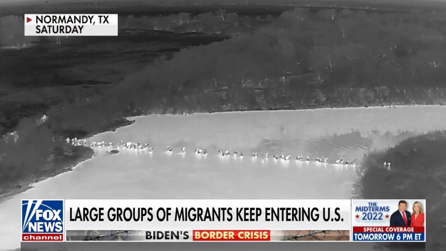 Fox News thermal footage of a line of people crossing a river at night.
