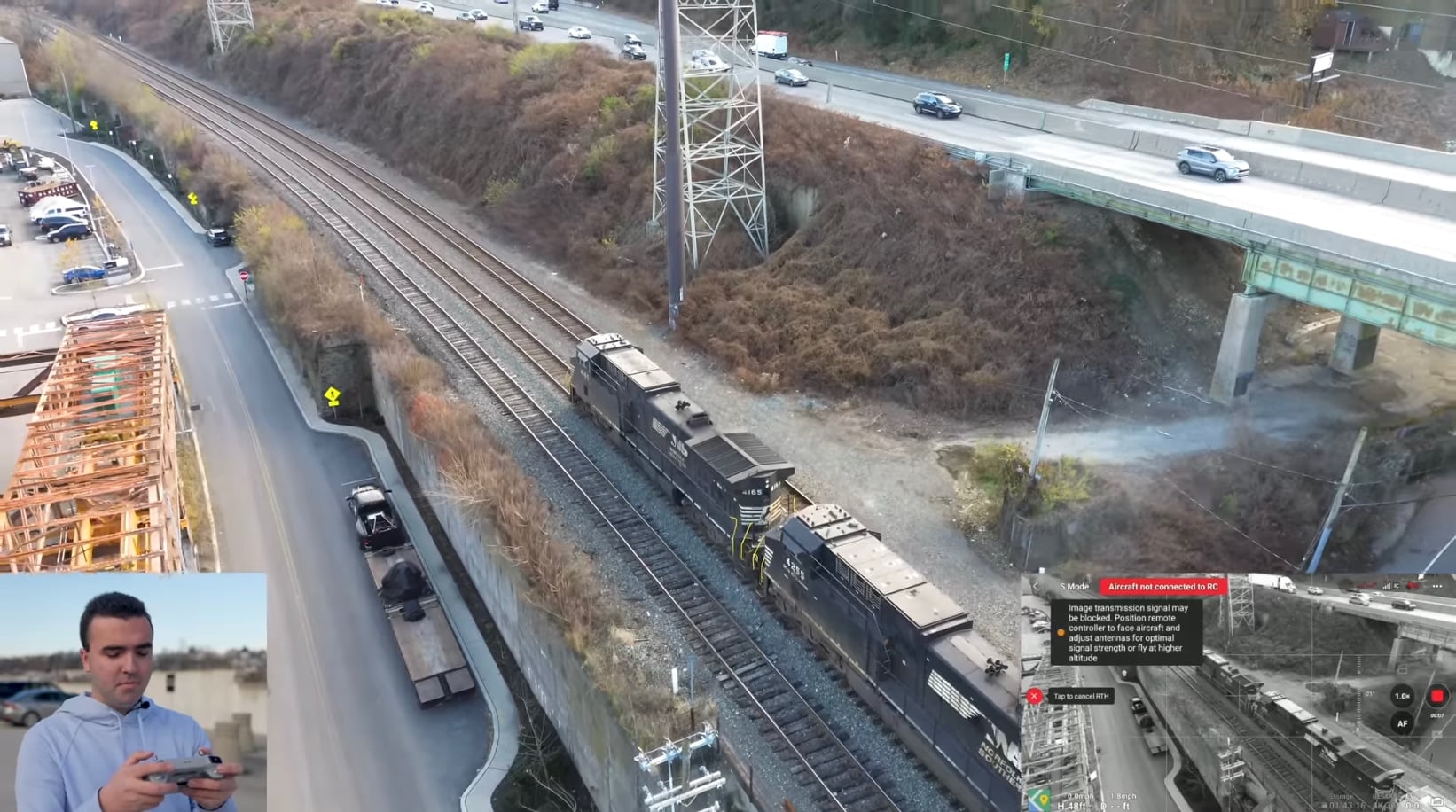 Pullback reveal of a passing train shot on the Mini 3 in automatic exposure.