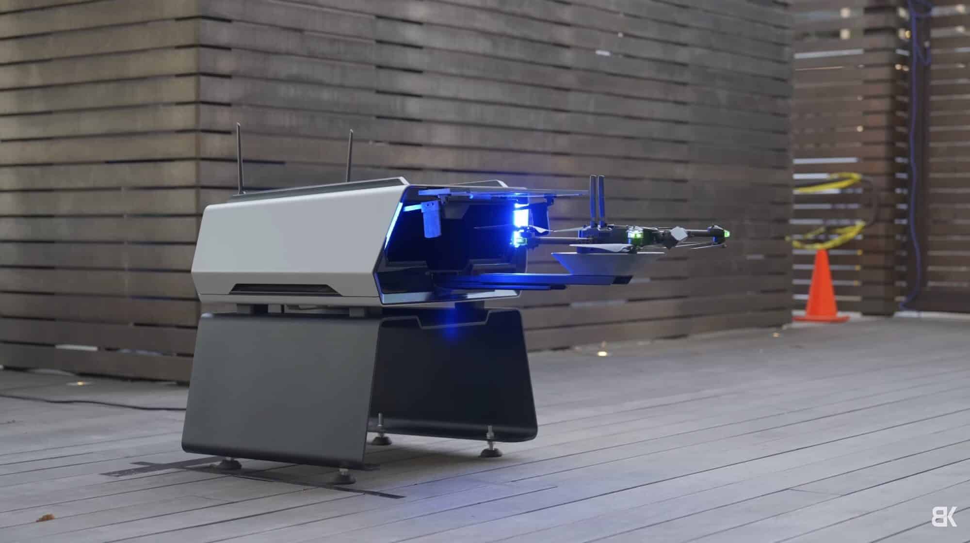 Skydio drone touching down on the cup-shaped landing pad of the dock arm.