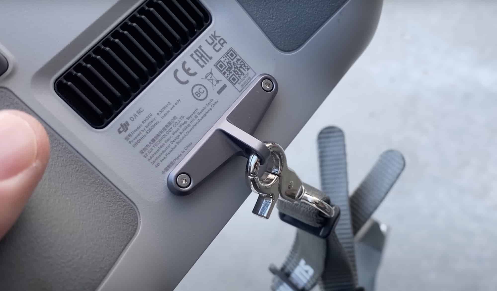 The StartRC neoprene strap clipped to the eye screws on the DJI RC controller.