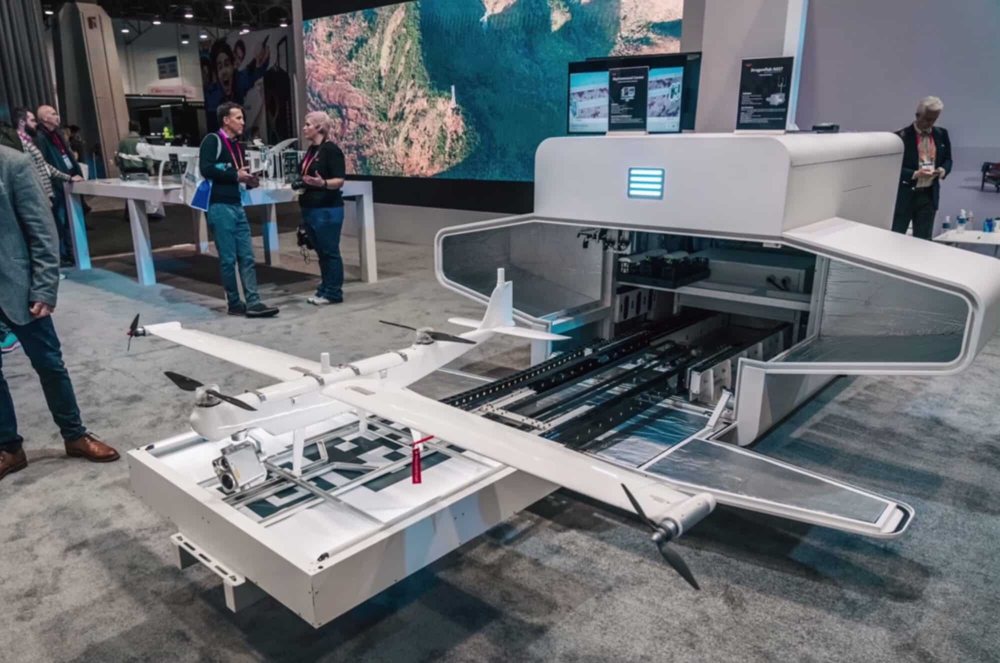 Autel Dragonfish VTOL drone displayed beside its large white docking station at CES.