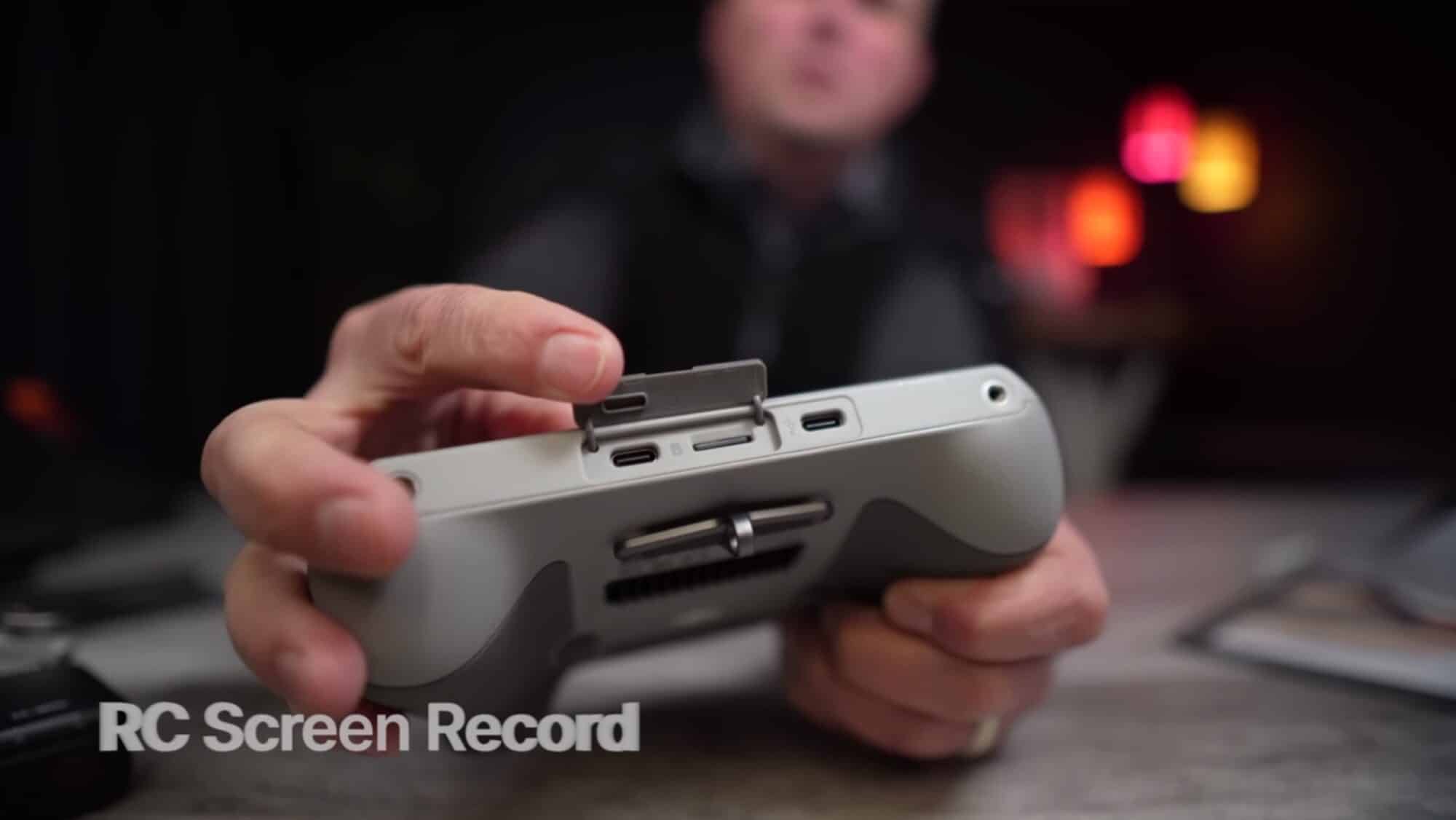 Hands holding a DJI RC with a screen record label over the footage.