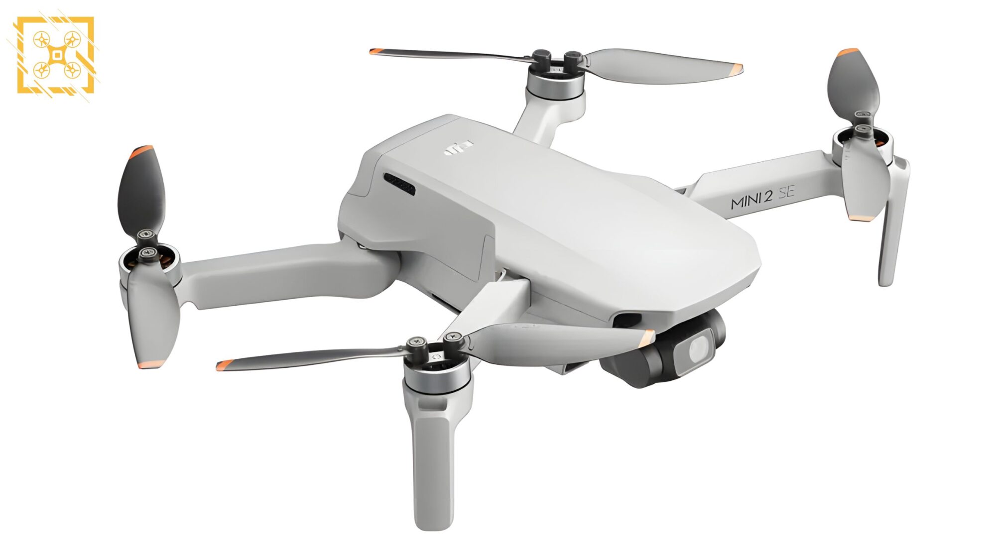DJI Mini 2 SE pictured alongside its remote controller and spare batteries.
