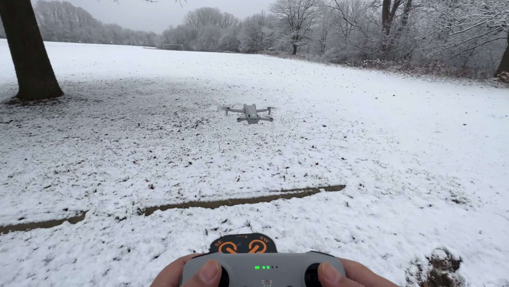 A foldable landing pad thrown over snow to give the drone a hard takeoff surface.