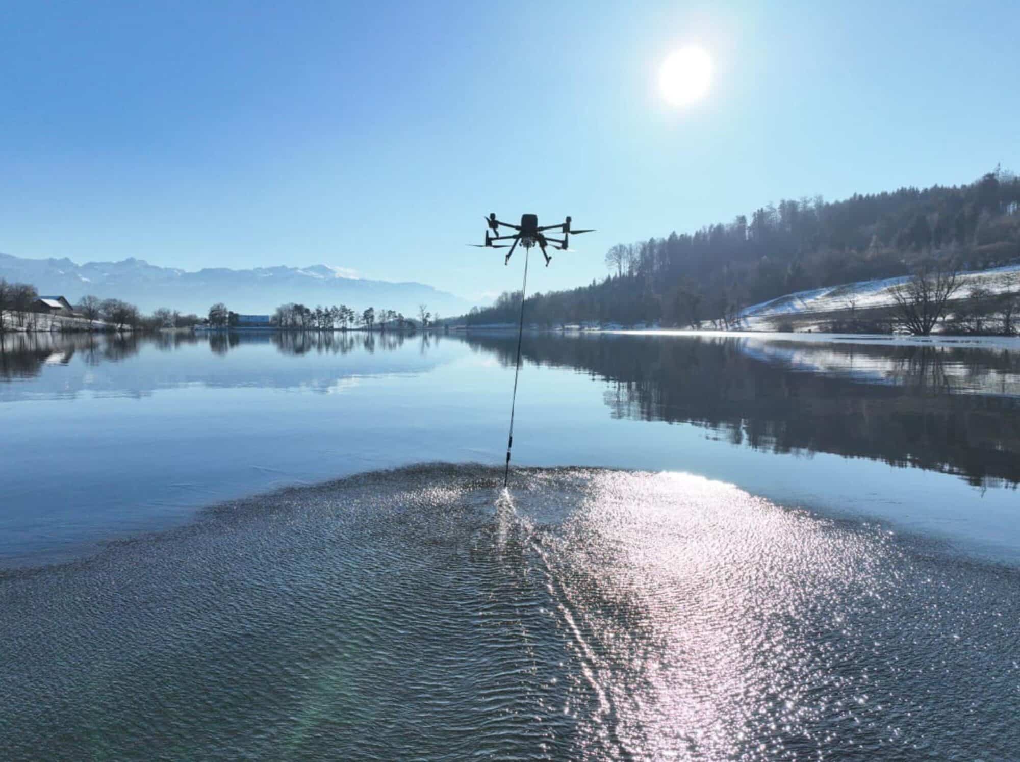 The Aquamapper echosounder gliding through the water behind the DJI M300 during the survey.