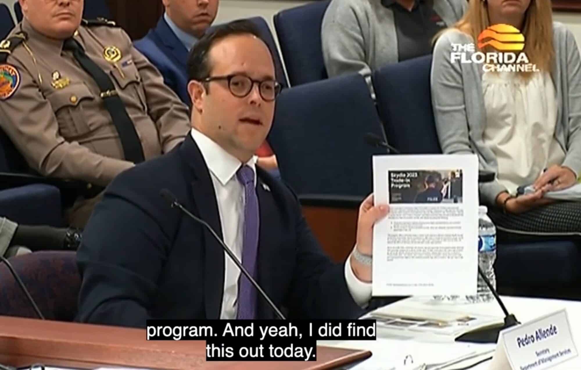 Secretary Pedro Allende holds a document while testifying before a Florida Senate committee.