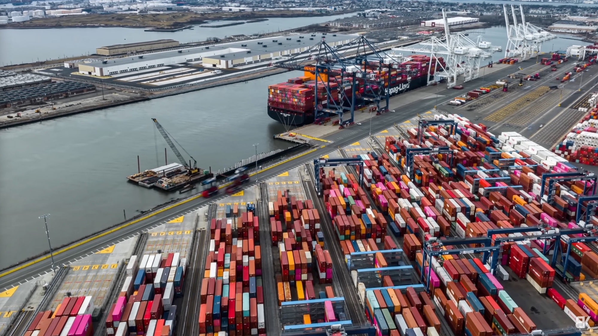 Aerial hyperlapse over a busy shipping port south of New York City.