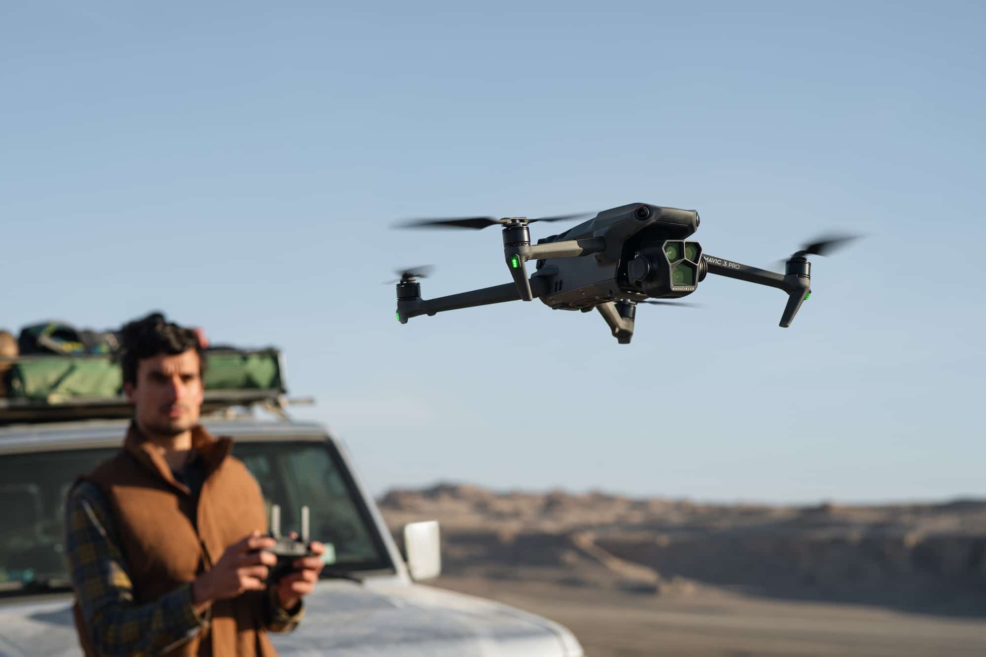 Lifestyle press shot of the DJI Mavic 3 Pro triple-camera drone.
