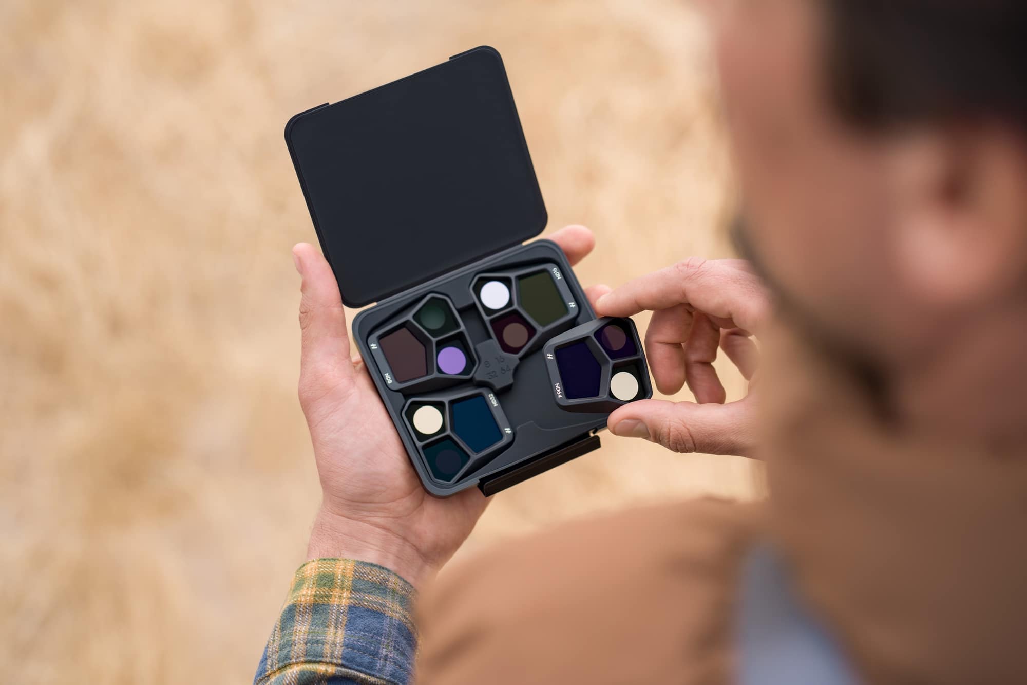 ND filters being fitted to the Mavic 3 Pro Hasselblad camera before a shoot.
