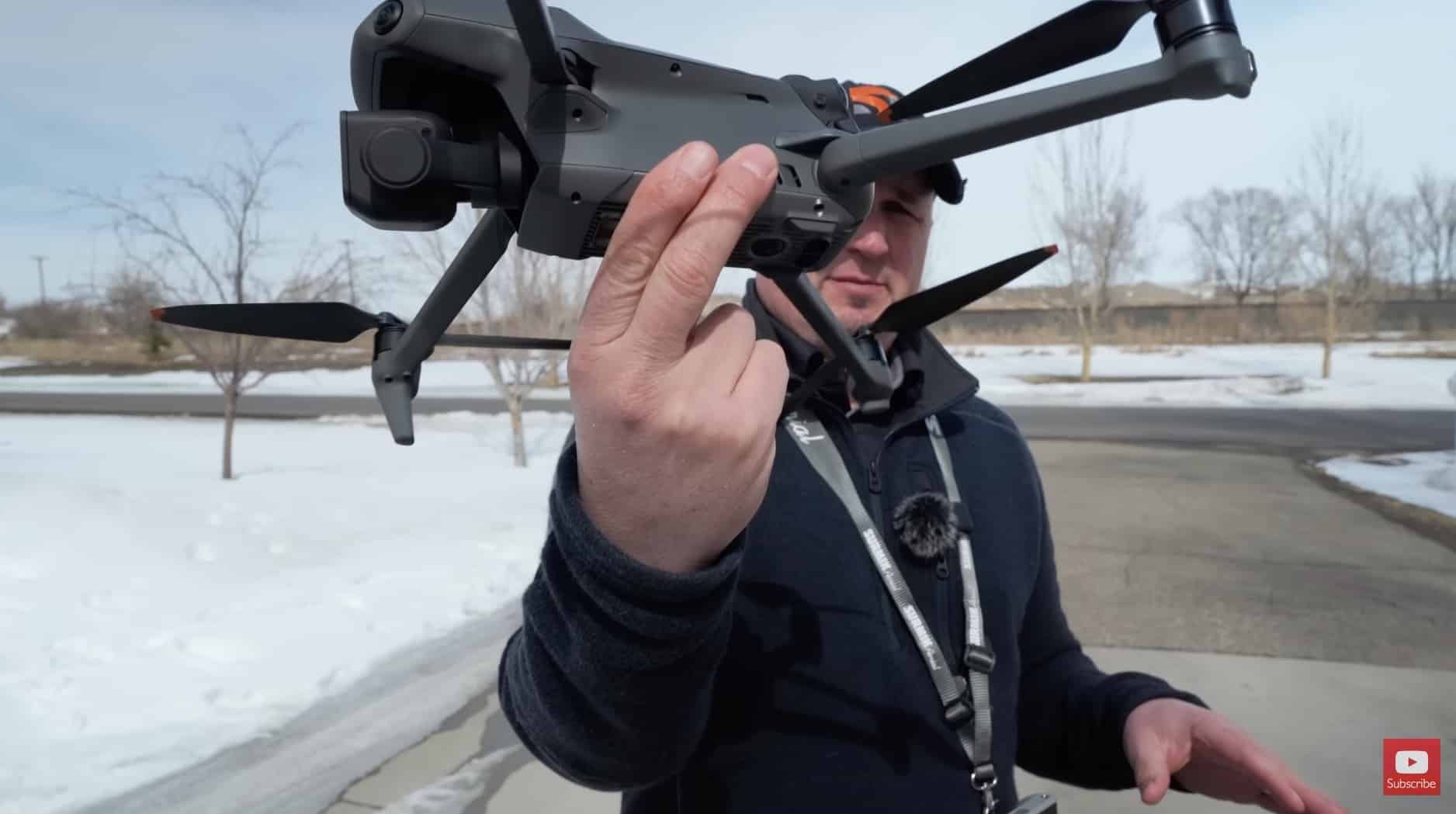 Russ of 51 Drones pinching the belly of a DJI drone for a hand launch.