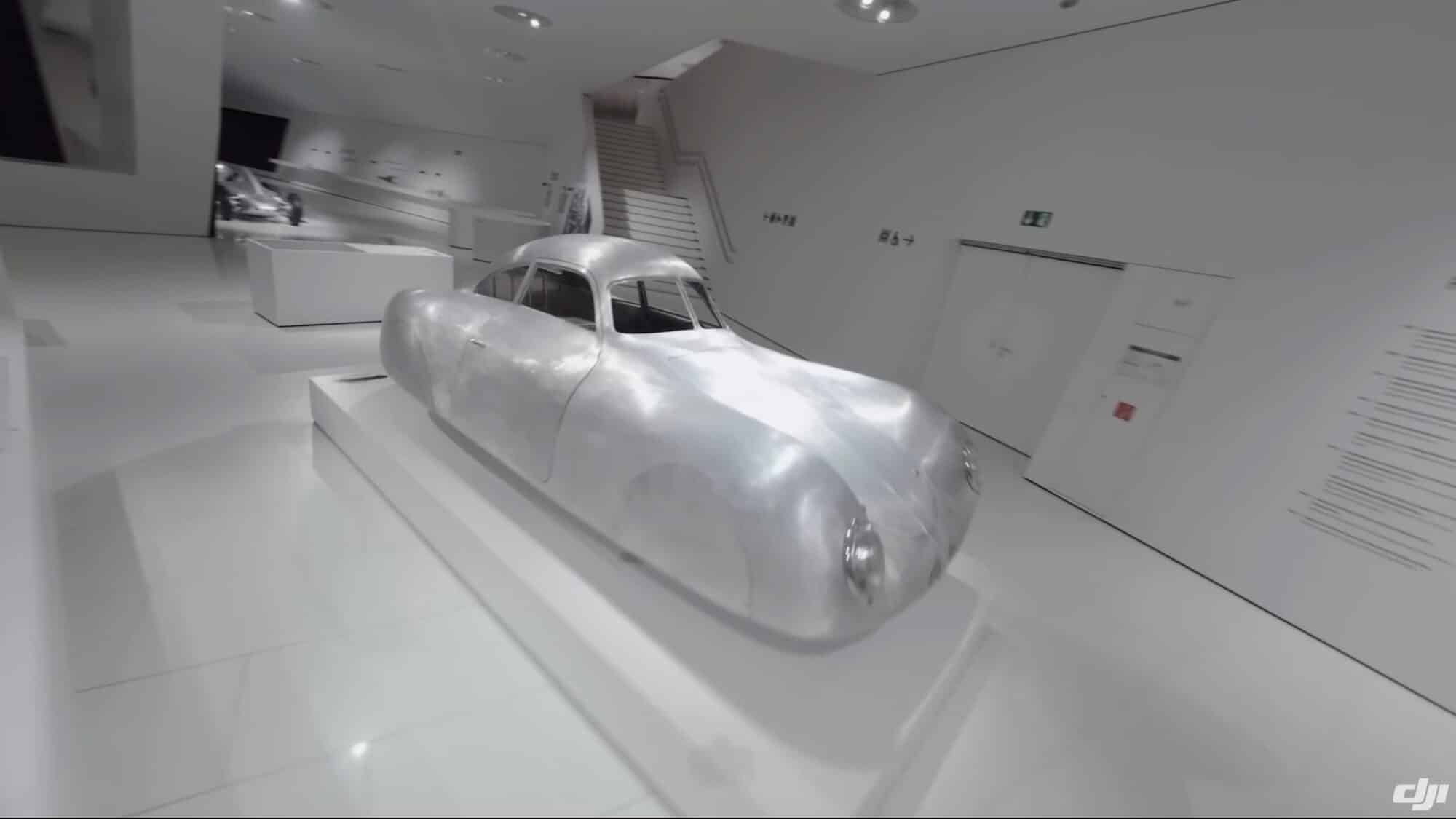 The DJI Avata flying inside the Porsche Museum, home to historic sports cars.