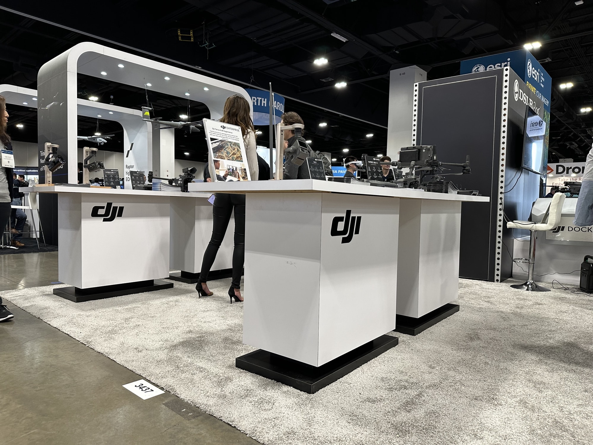 Empty DJI exhibition booth with bare counters at a trade show.