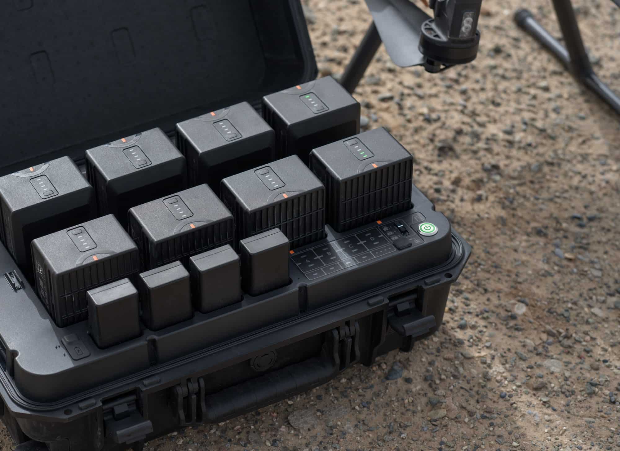 Operator holding the DJI RC Plus controller with its 7-inch screen.