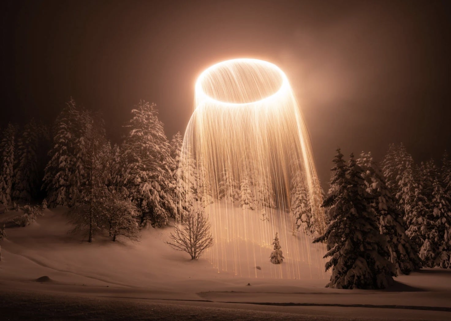 Long exposure of a fiery drone circle burning in the night sky.