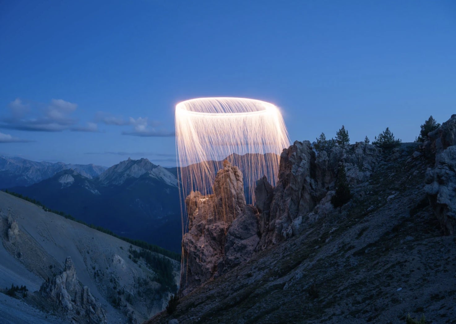 Drone light painting by Jadikan framing a natural landmark inside a fiery ring.