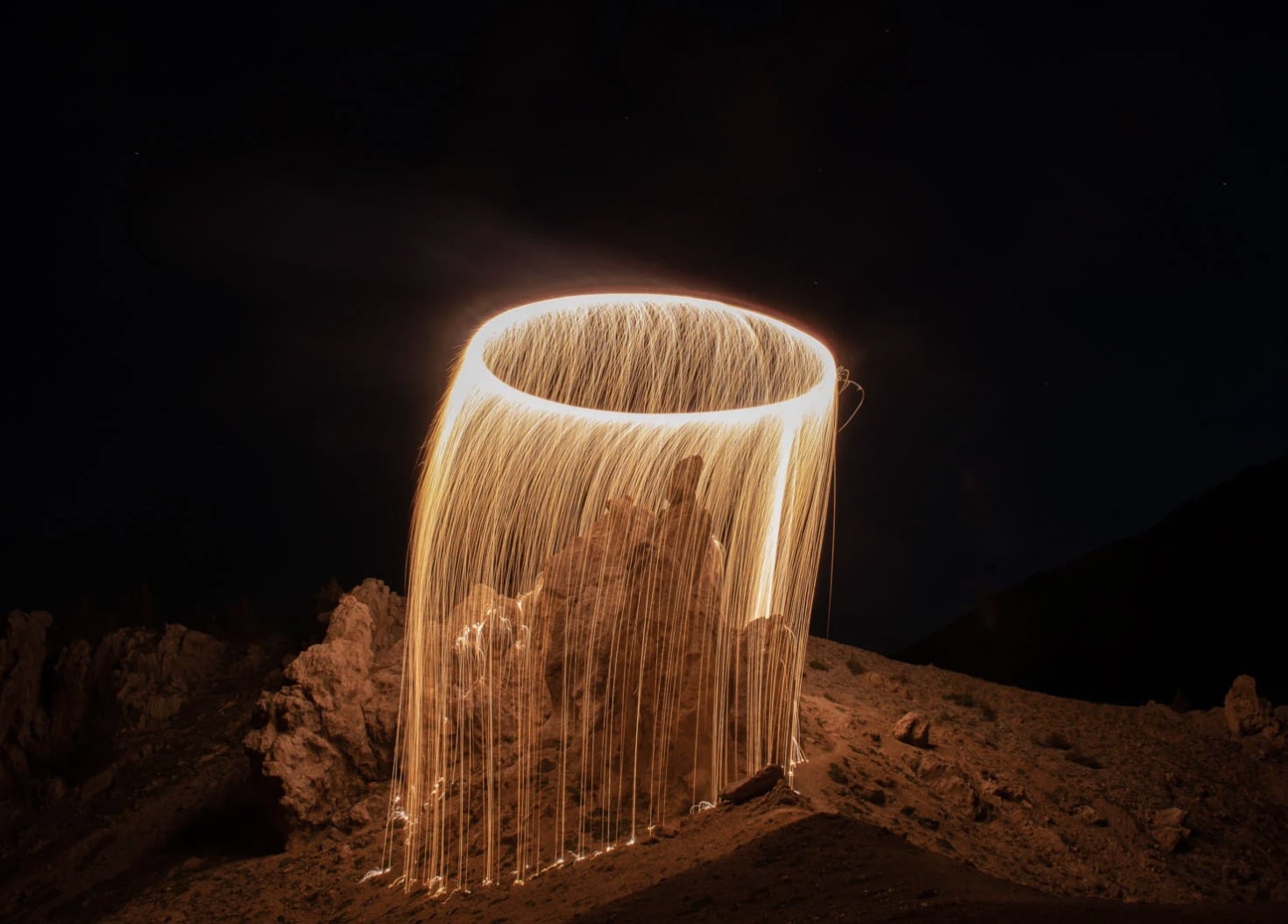 Night sky above the French Alps lit by a drone-drawn circle of fire.