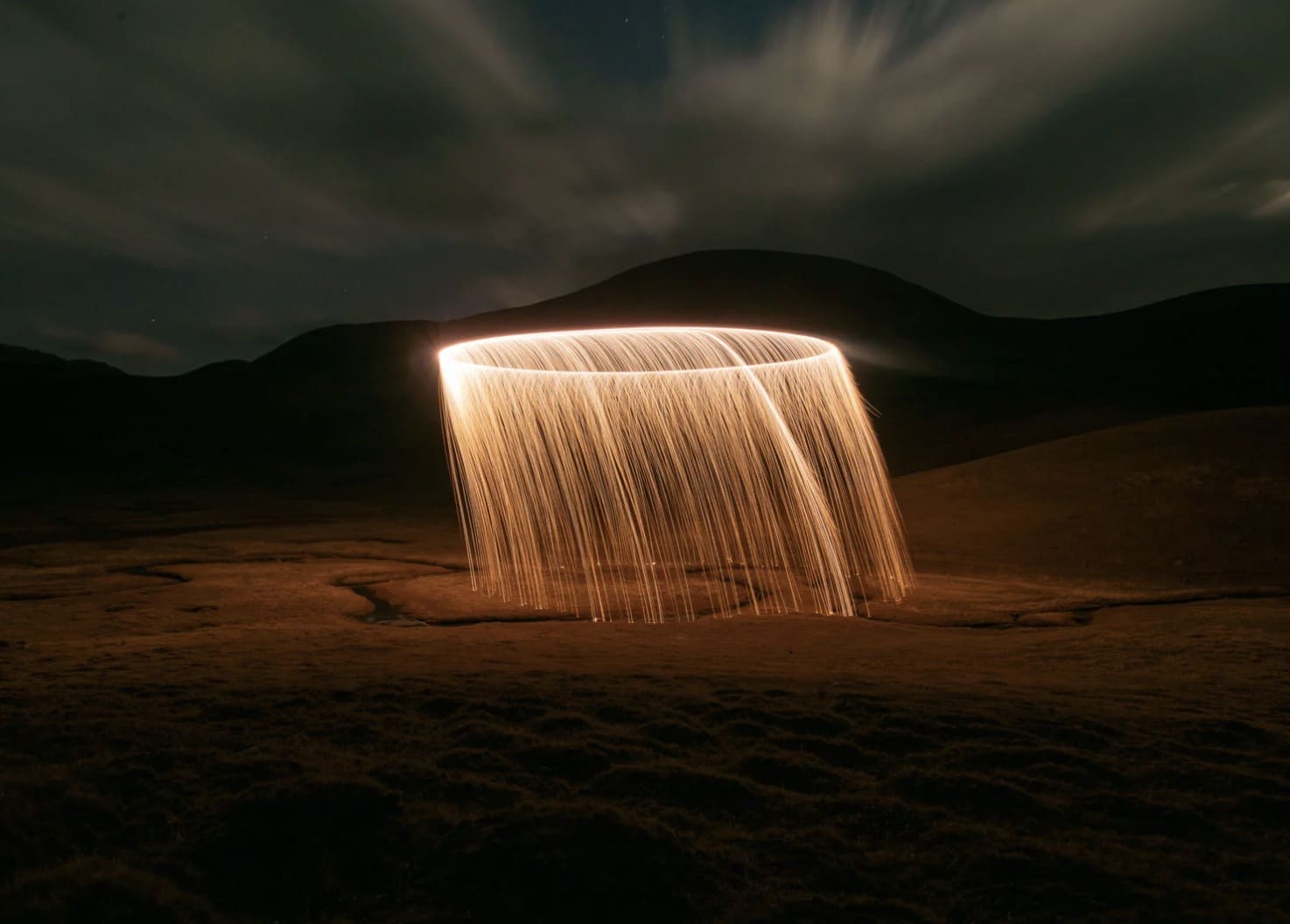Sparks from combustible powder carried by a drone, traced into a glowing ring.