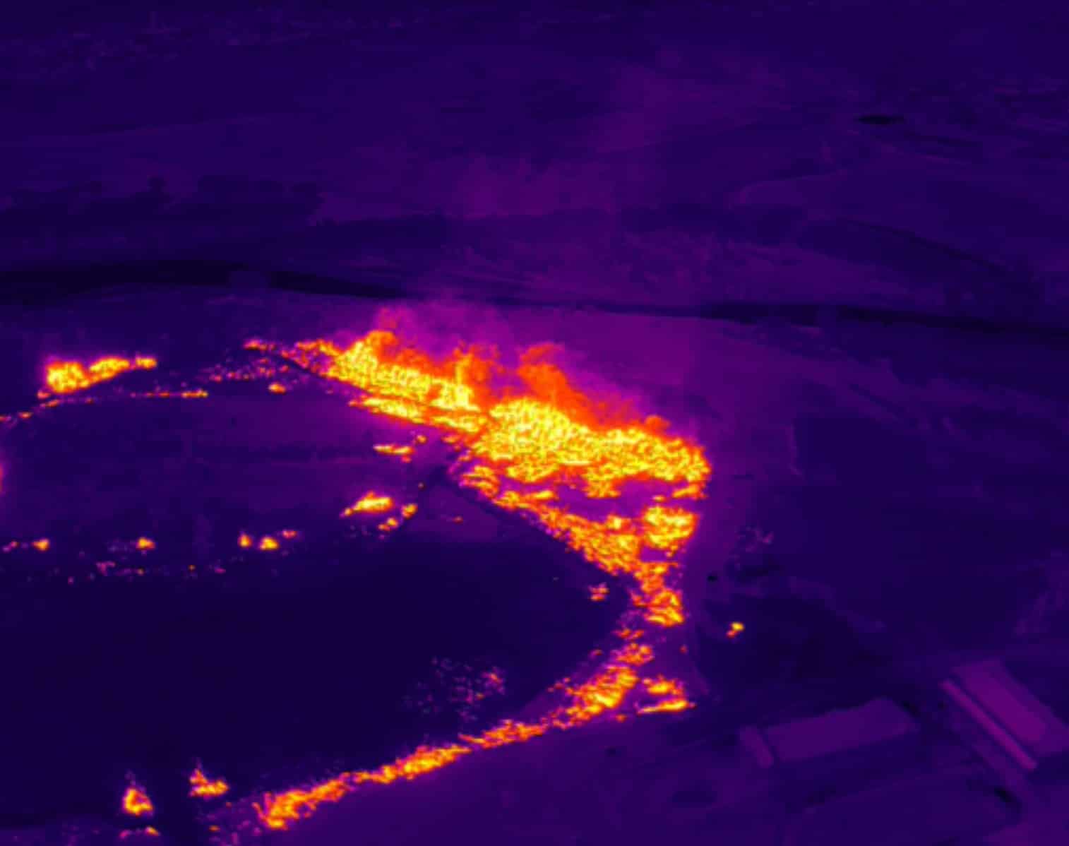 Infrared drone imagery maps the glowing fire perimeter and its hottest spots.