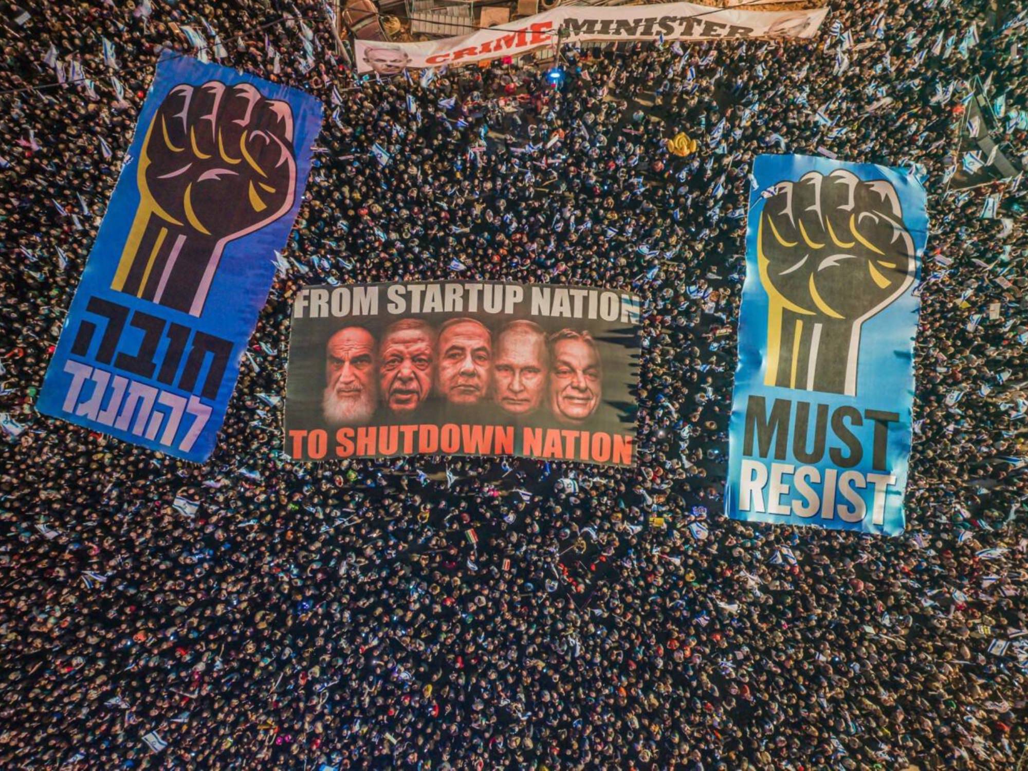 Must resist by Or Adar. Seen from above, protesters wave banners in a rally against the court restructuring proposals of Israeli Prime Minister Benjamin Netanyahu, in Tel Aviv. For the ninth consecutive week, on Saturday, March 4th, massive crowds gathered in cities across Israel to voice their opposition to the government's proposed judicial reforms.