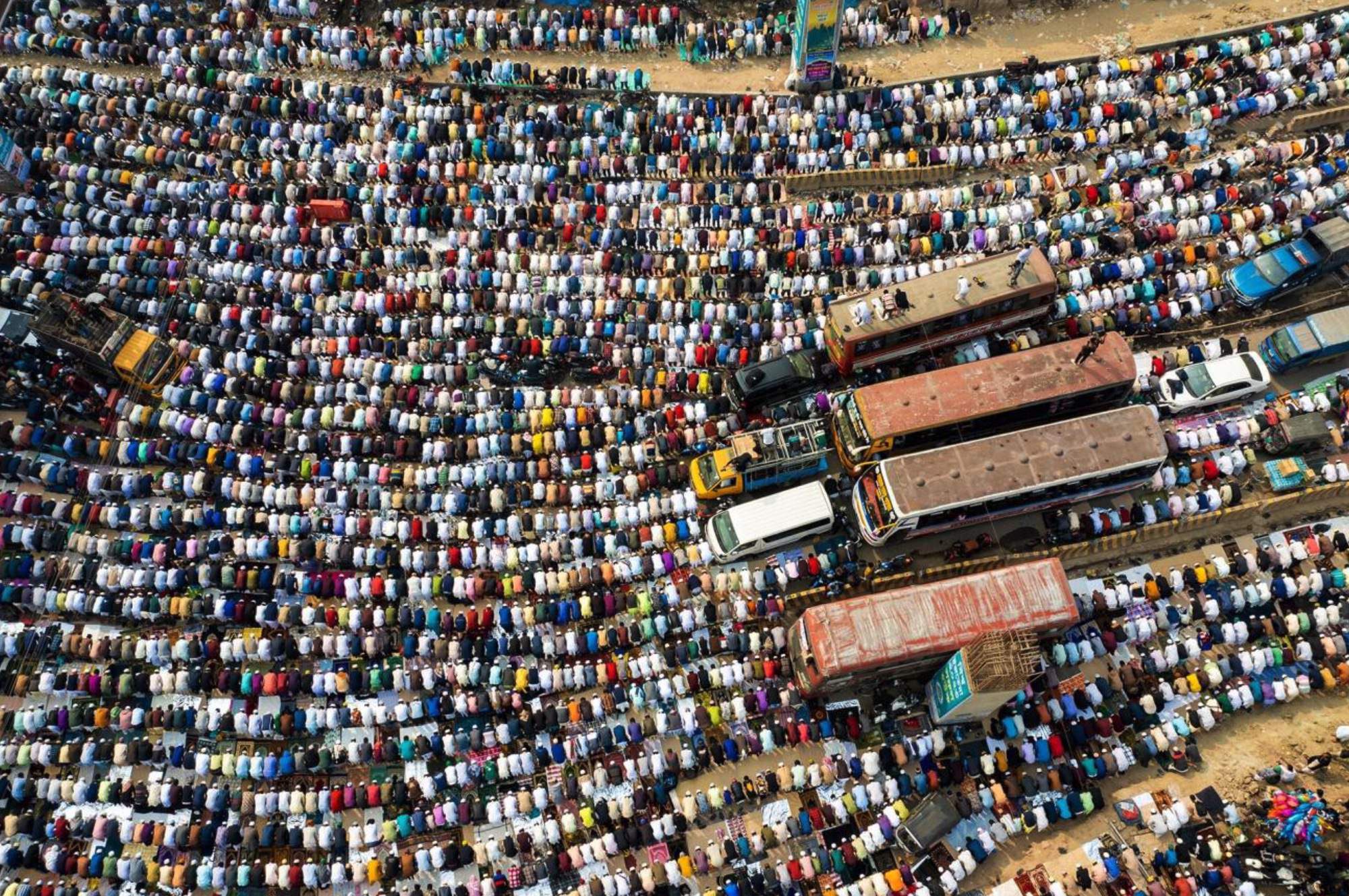 Jummah Prayer On Highway by Md Tanveer Hassan Rohan. A bird's-eye view captures the immense gathering of thousands of faithful participating in Jumma prayer on the Dhaka-Mymensingh highway, marking the first day of Bishwa Ijtema 2023. This event is recognized as the second biggest global assembly of Muslims, surpassed only by the hajj.