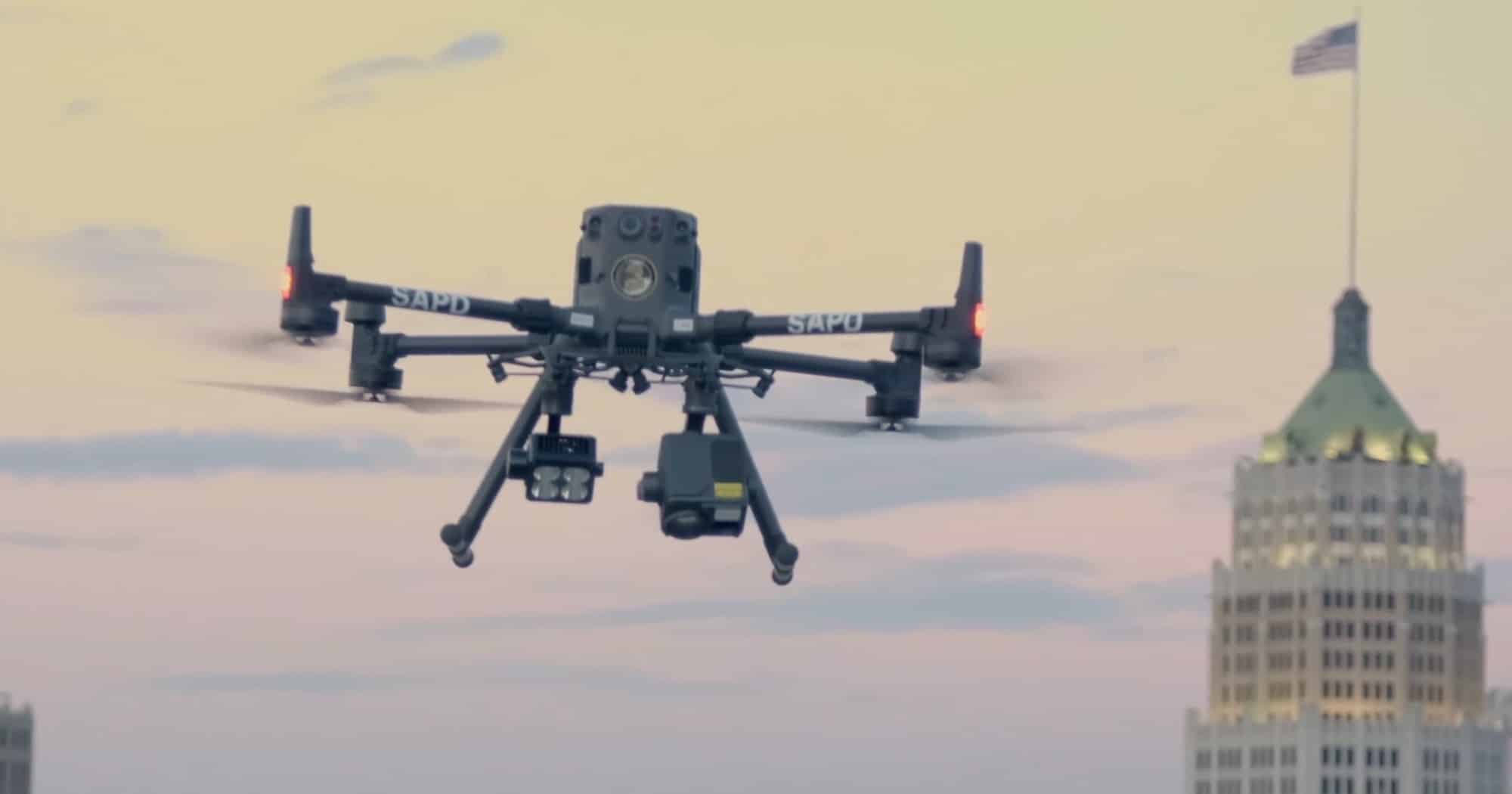 A DJI Matrice marked SAPD flying above downtown San Antonio rooftops.