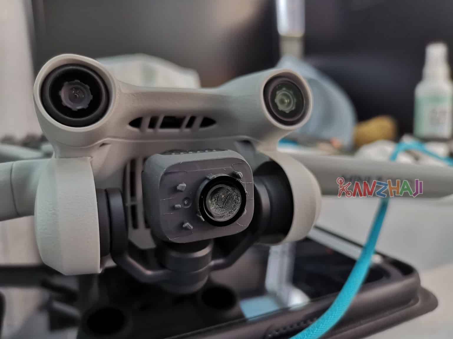 Close-up of a fogged DJI Mini 3 Pro camera lens on a workbench.