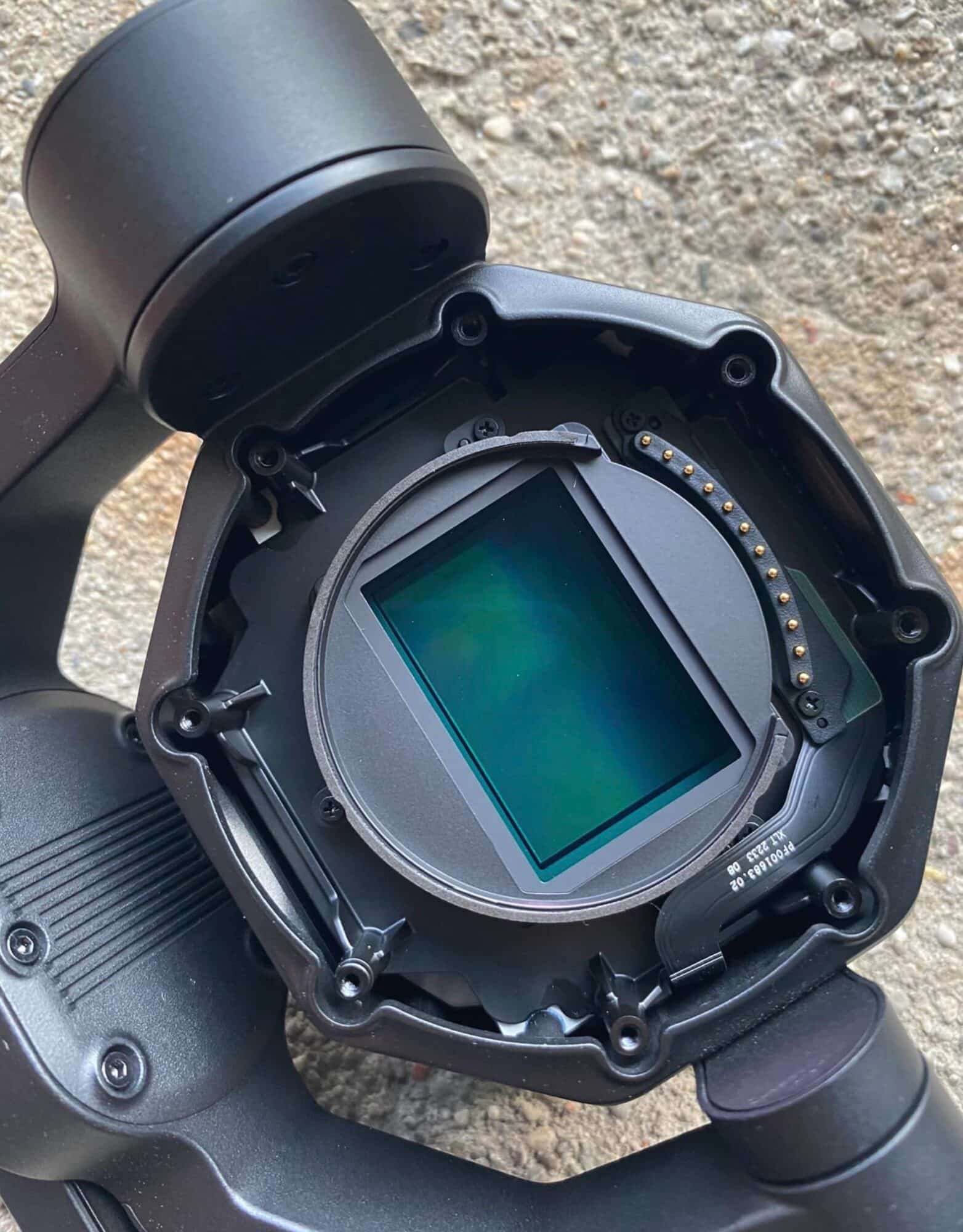 Close-up of a DJI X9 camera with its lens mount removed exposing the sensor.