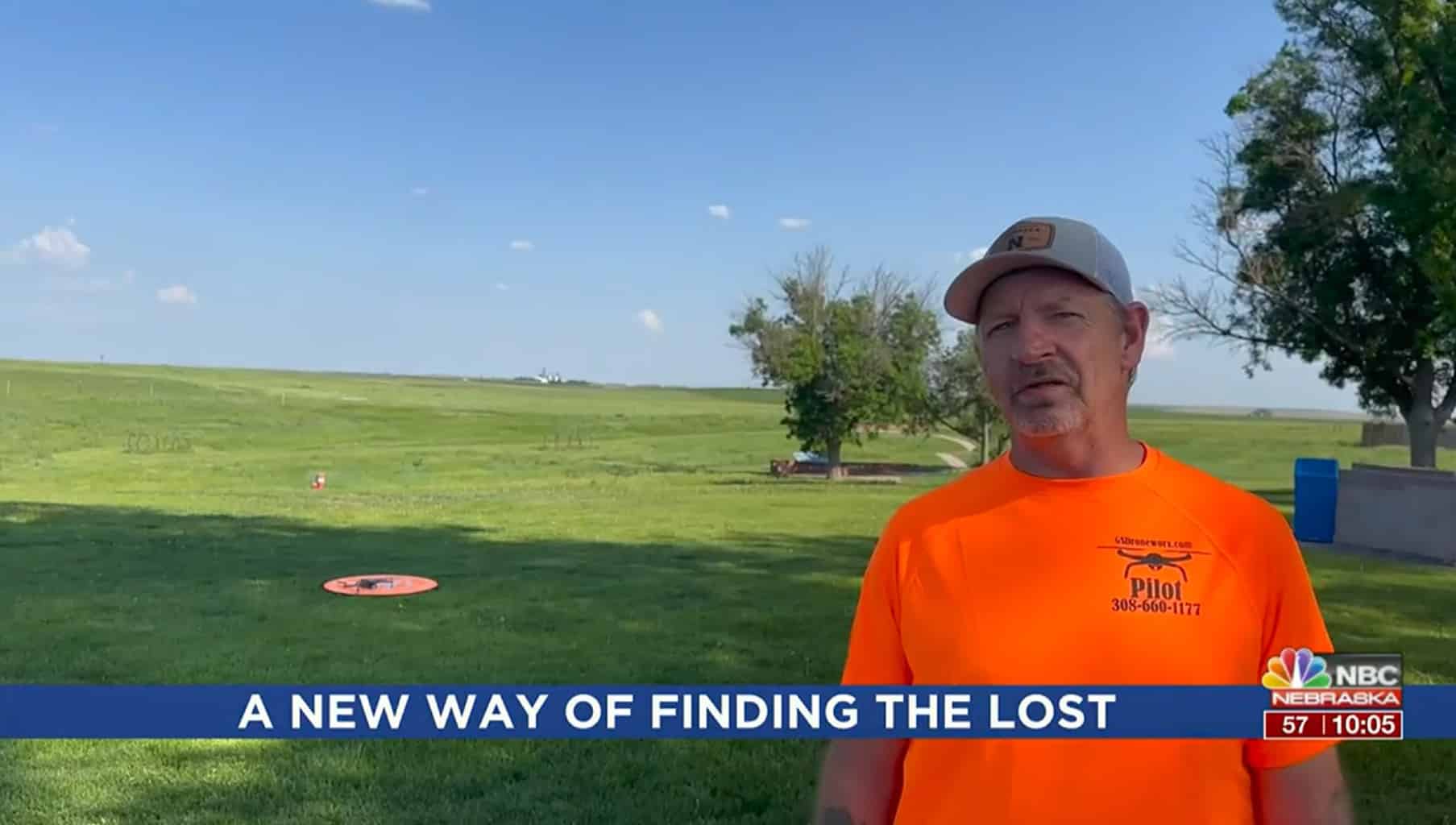 Volunteer drone pilot interviewed in a Nebraska field by a television crew.