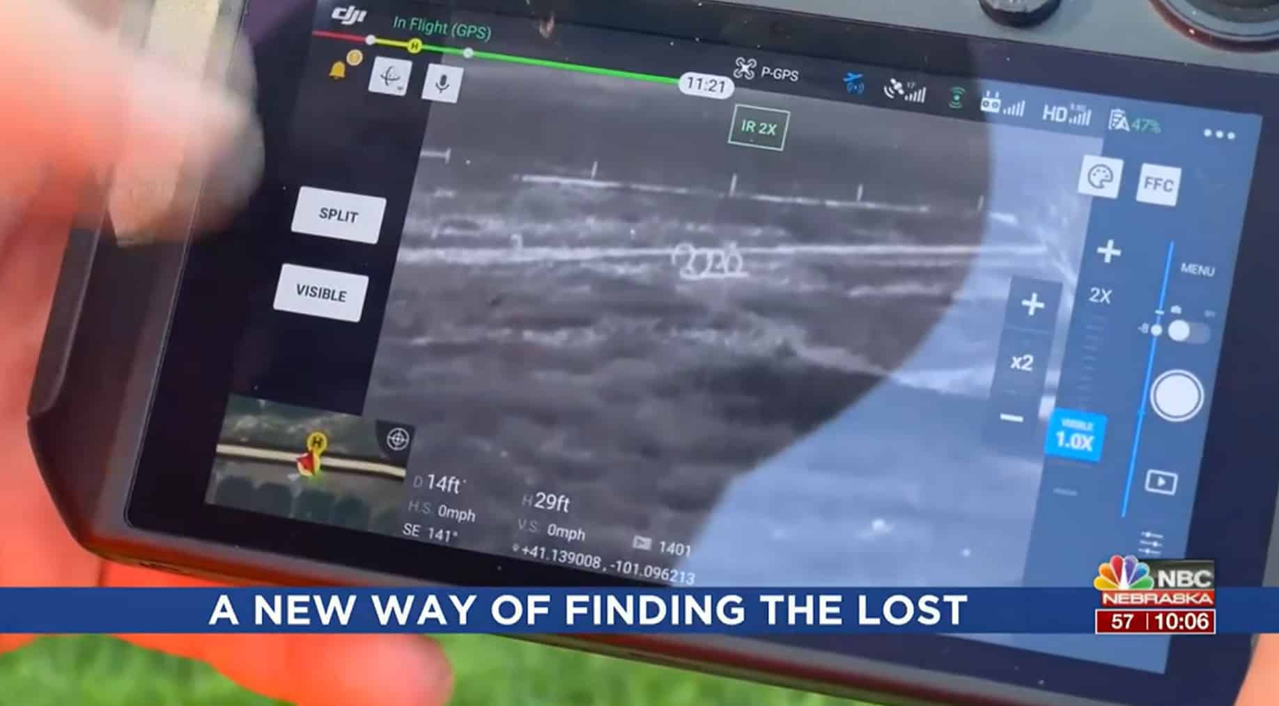 News clip of a controller screen showing thermal drone search footage.