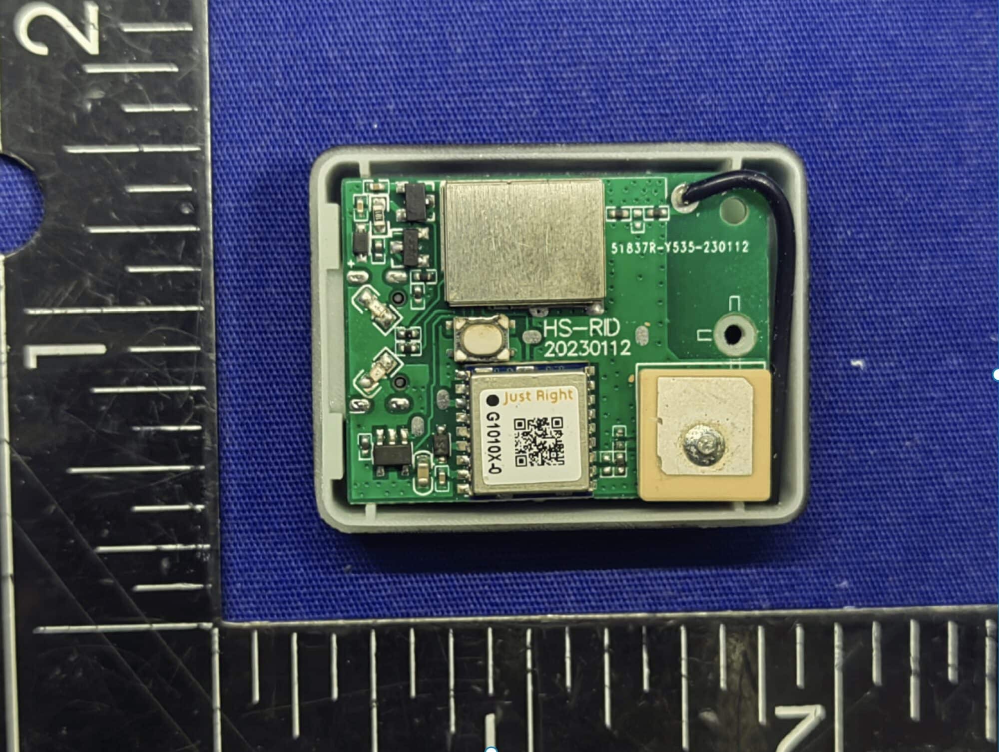 A tiny Holy Stone Remote ID circuit board beside a ruler for scale.