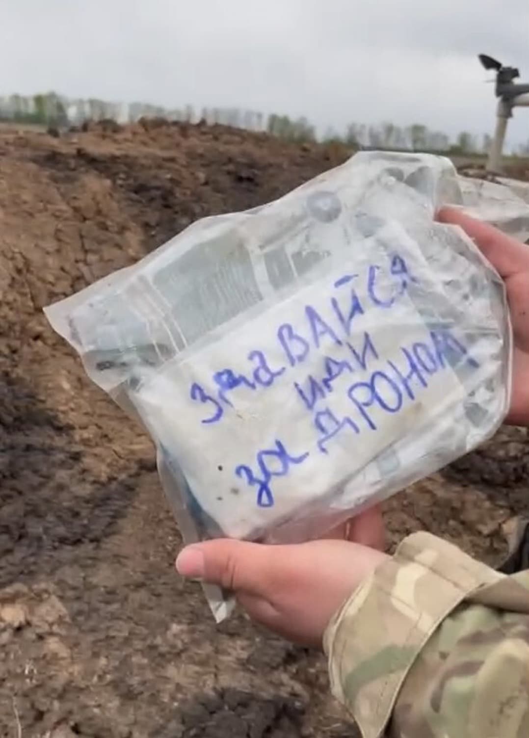 Ration packaging carrying a handwritten Russian note reading surrender and follow the drone.