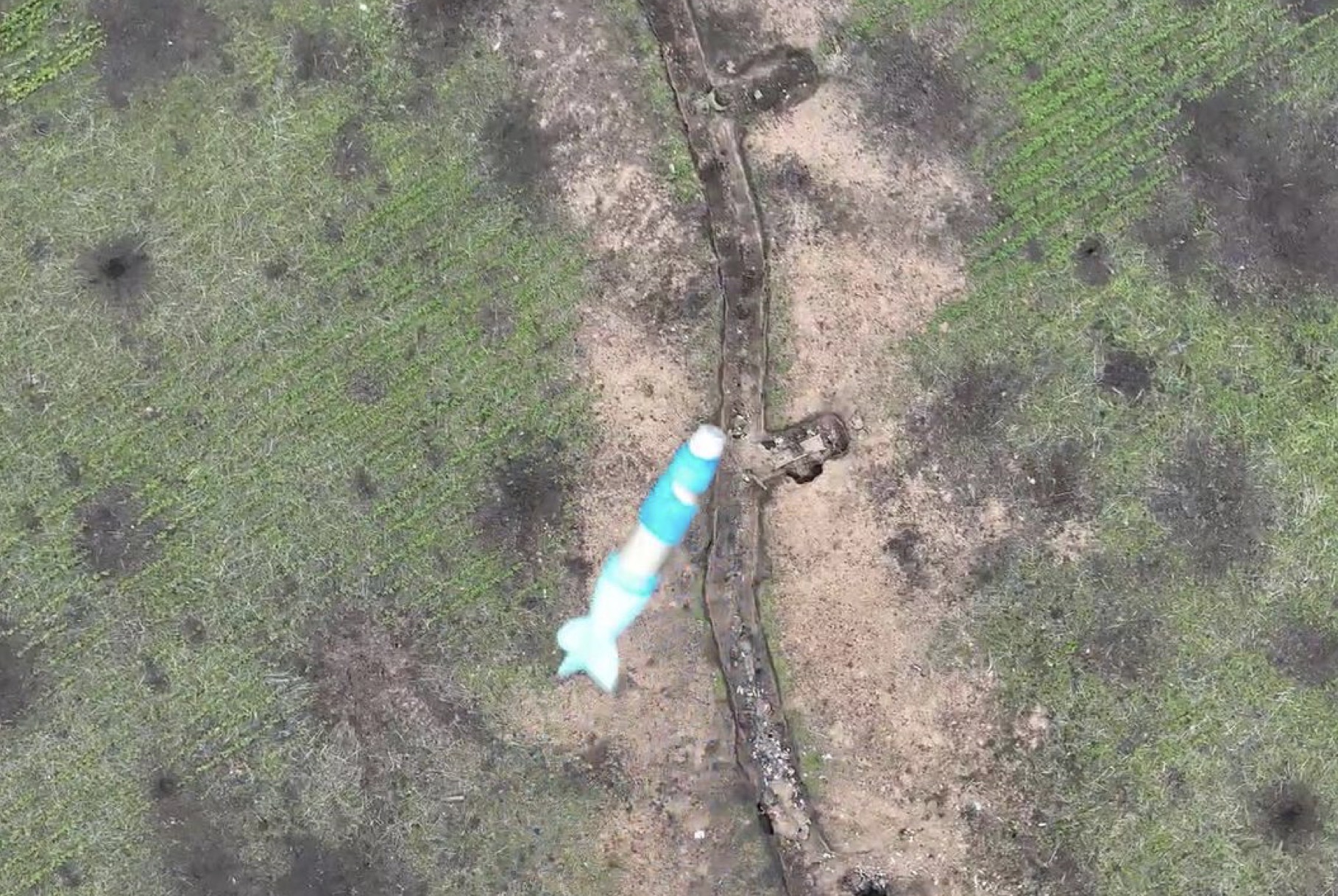 A modified DJI Mavic 3 releases an explosive over the Russian soldier's trench.