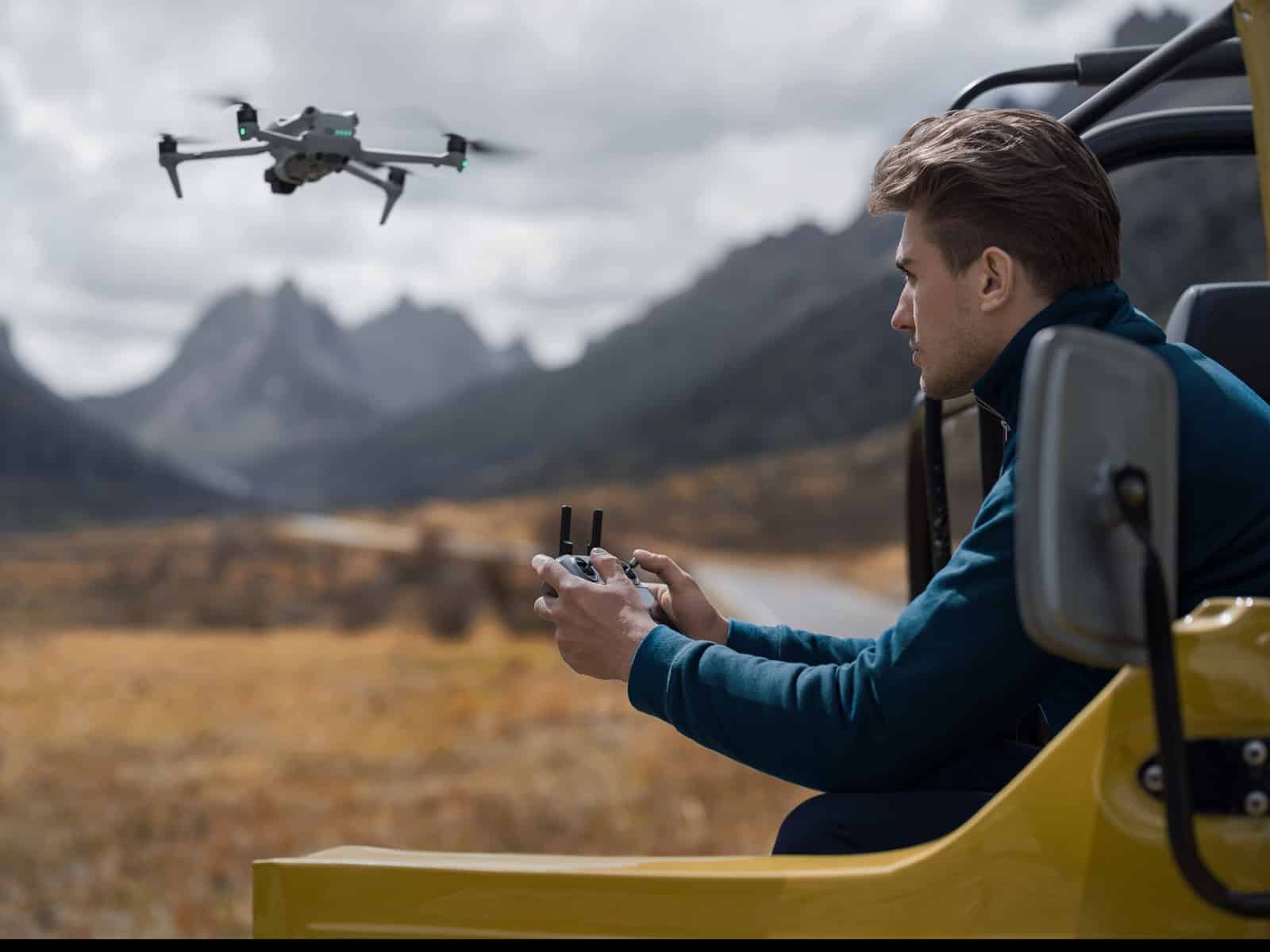 Lifestyle shot of a pilot launching the DJI Air 3 outdoors.