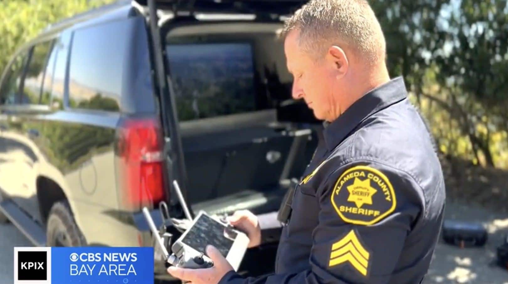 Deputy John Cota watching the live drone feed on his controller screen.