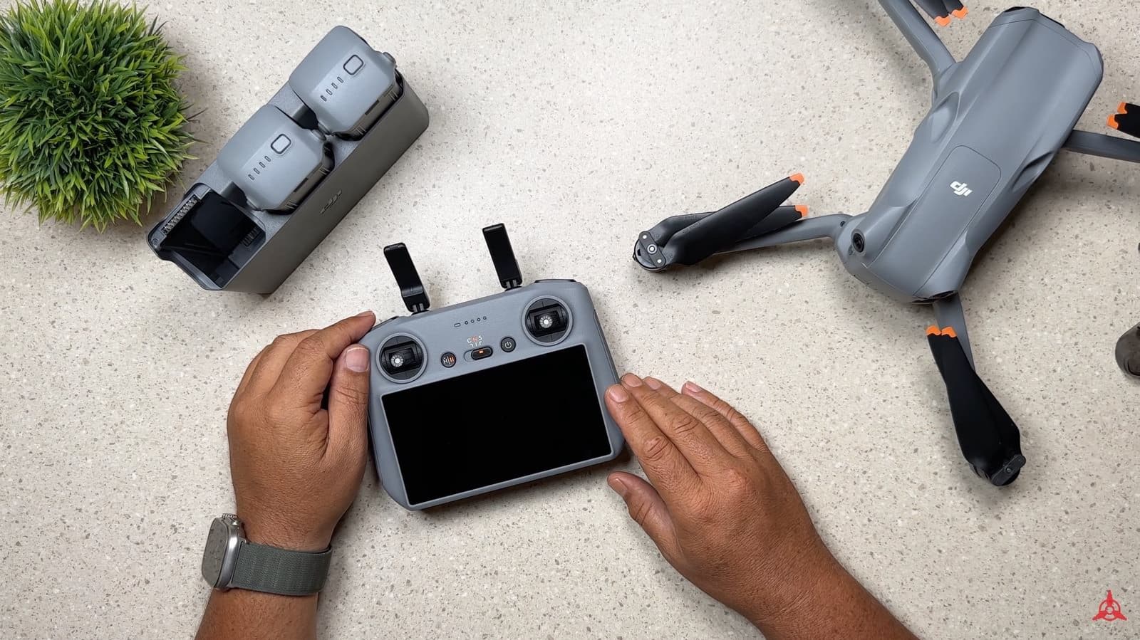 DJI Air 3 batteries charging one at a time in the Fly More kit hub.