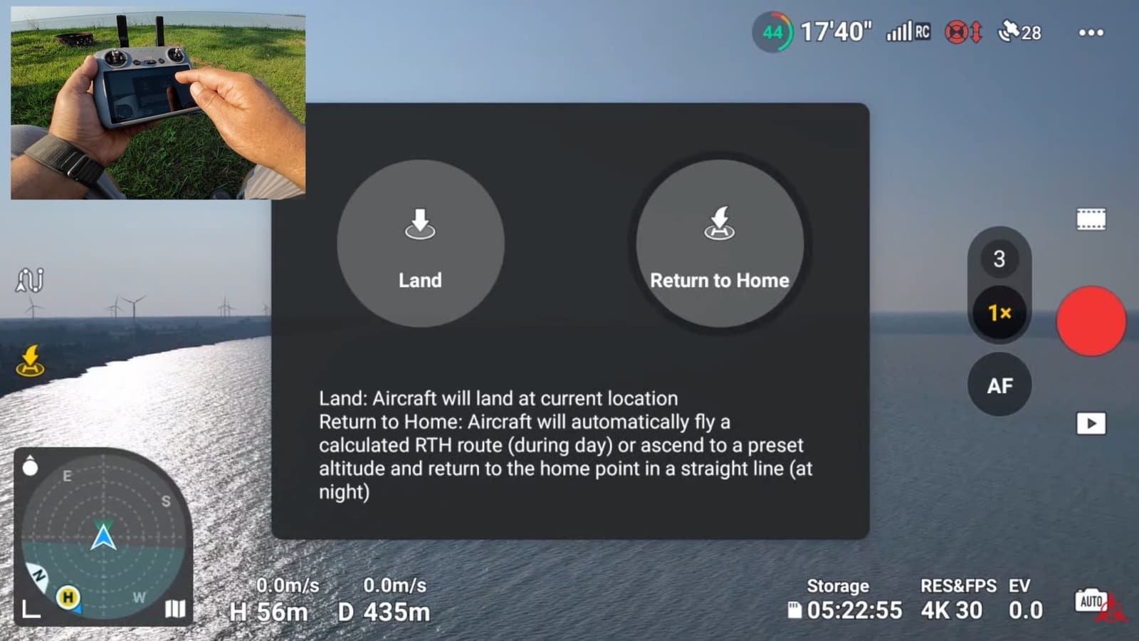 Return to home prompt in DJI Fly offering land and return to home options.