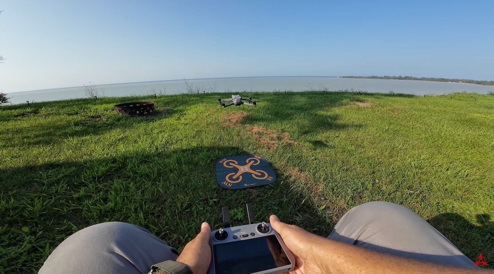DJI Air 3 touching down on the landing pad at the end of the beginner guide.