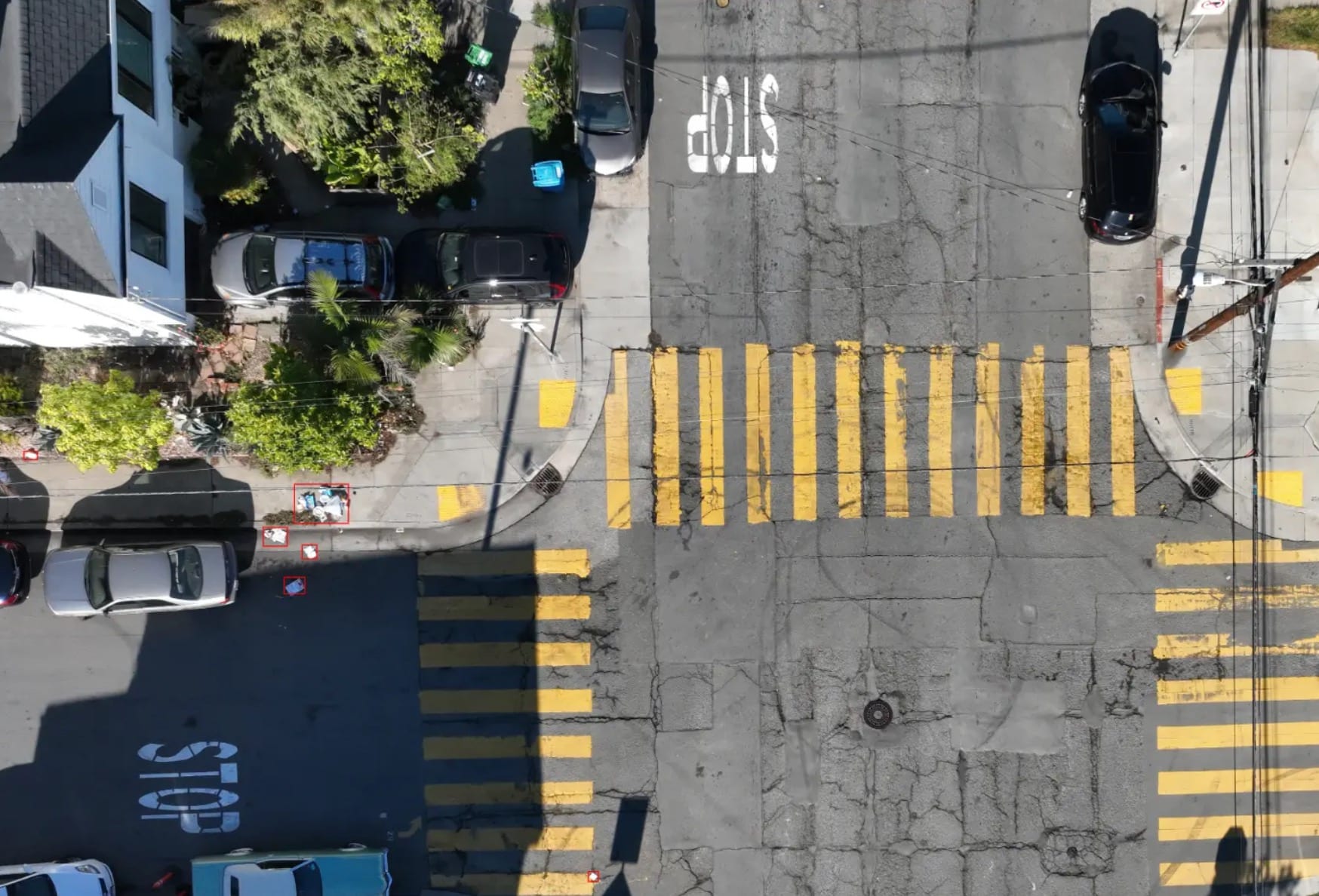 Overhead drone view of illegally dumped debris beside a San Francisco intersection.