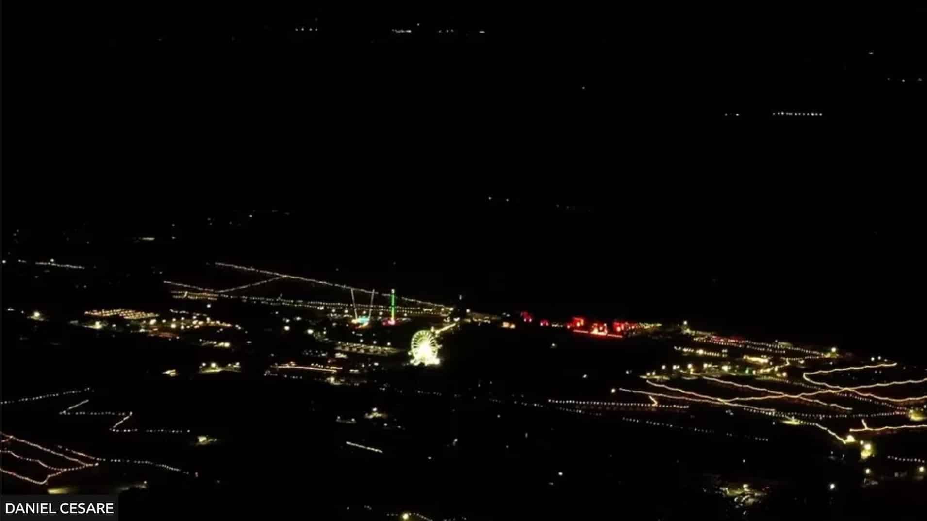 Night aerial footage of a town's lights captured during the unauthorized flight.