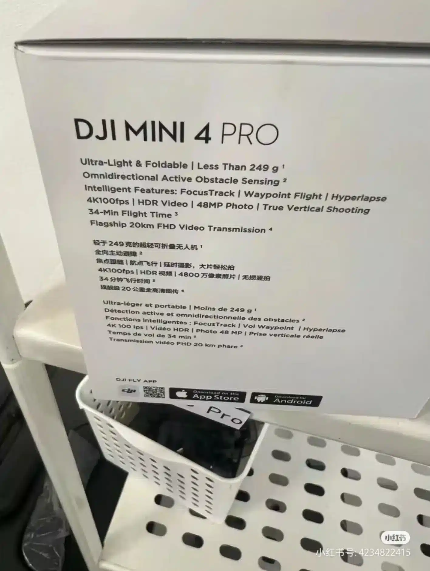 Side of a DJI Mini 4 Pro box listing specifications on a store shelf.