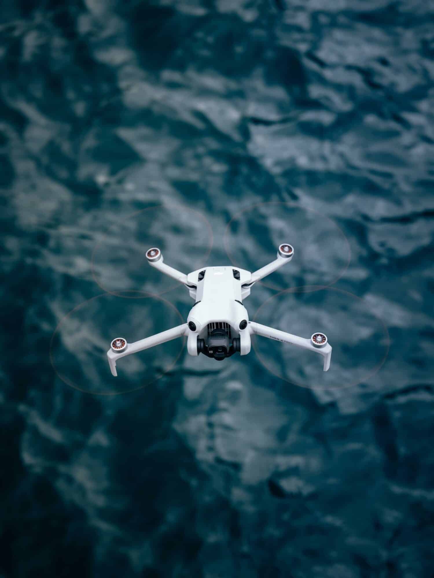 Portrait lifestyle shot pairing the DJI Mini 4 Pro with the DJI RC 2 controller.