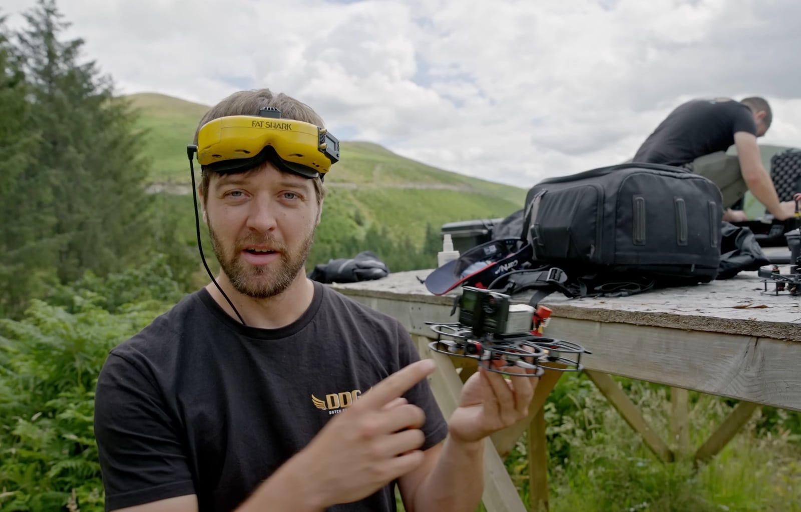 FPV drone footage tracking the rider down the Red Bull Hardline course.