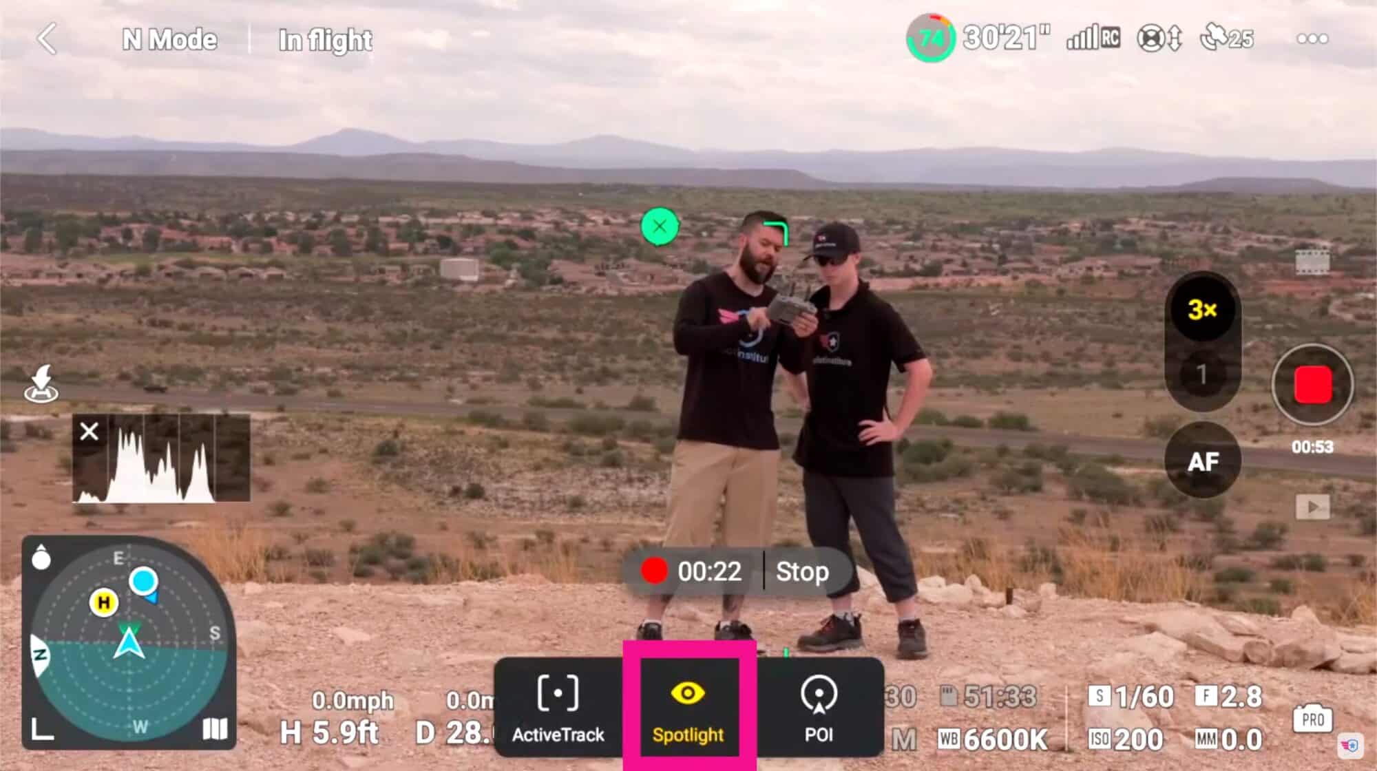 Screenshot of the DJI Fly interface with Spotlight selected while filming two people.
