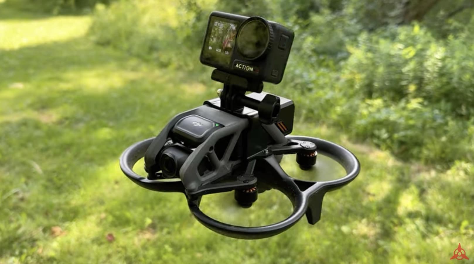 A DJI Avata flying over grass with an Osmo Action camera mounted on top.