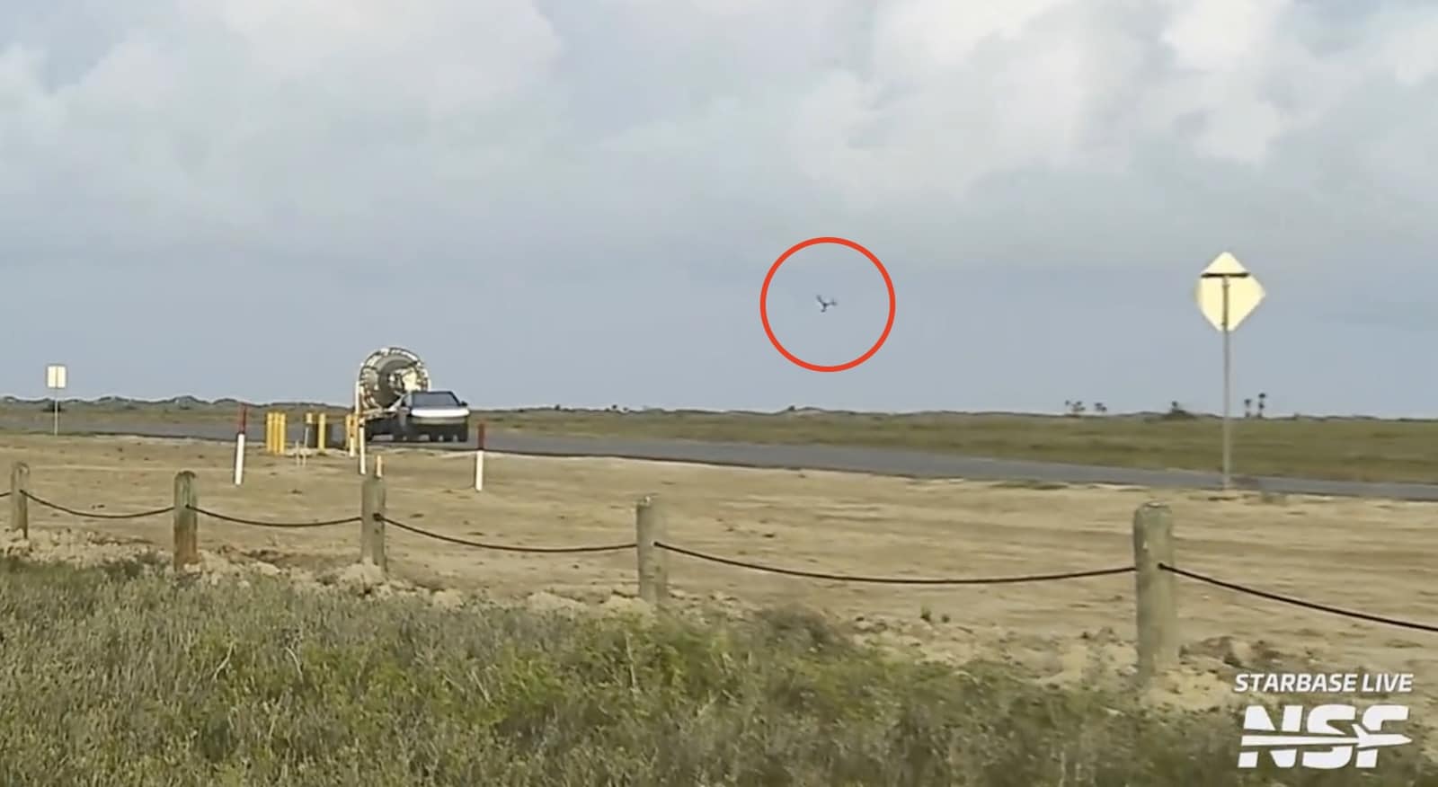Starbase live frame circling a small drone in the sky above the launch site.