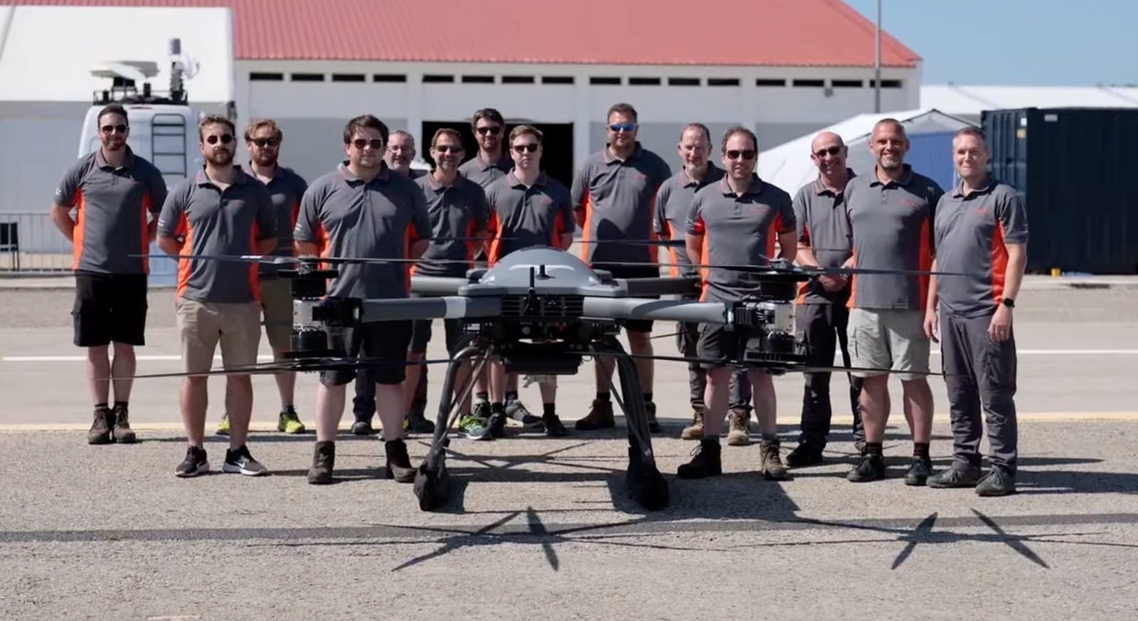 The BAE Systems team stands with the T-600 outside a hangar at REPMUS.