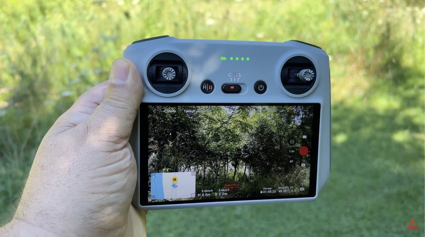 Top-down look at a DJI RC remote controller with its sticks folded away.
